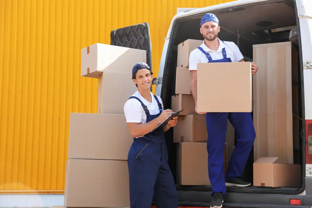 Professional movers carefully loading furniture into a moving truck
