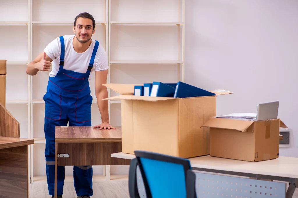 Efficient packing of office supplies by Moving You Now Kendall's skilled moving team.